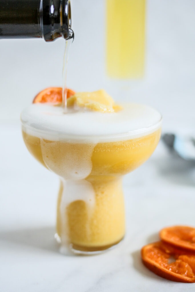 pouring champagne in a margarita