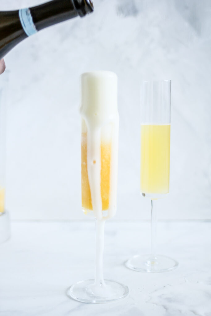 pouring champagne for Frozen Mimosas